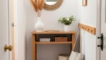 Coastal Entryway Ideas: 9 Easy Swaps for a Small Entryway (Before and After) 7 Small coastal entryway after makeover with light oak console, round rattan mirror, pampas grass and striped blue runner