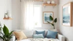 Small Apartment Coastal Decor: 7 Renter-Friendly Swaps 5 Small studio apartment after a coastal makeover, with a white linen sofa bed, sheer curtains, a jute rug and a rattan pendant